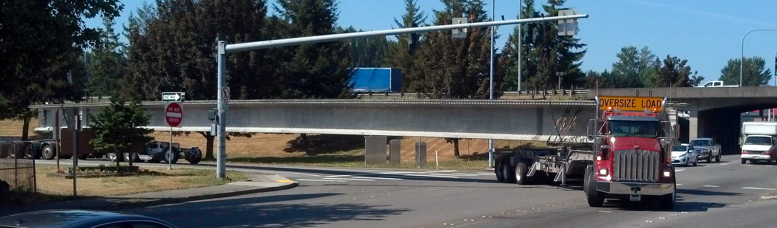 V Van Dyke truck navigating a sharp turn with long girder