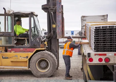 Forklift loading truck with employee guidance